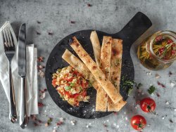 Fette di focaccia con pomodorini,olive,finocchio,basilico e aglio image